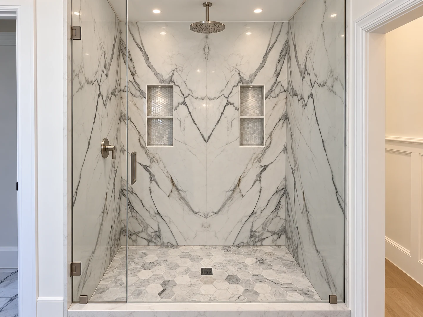 Bookmatched white and gray stone shower walls with recessed niches; retouched setting, stone color and veining preserved