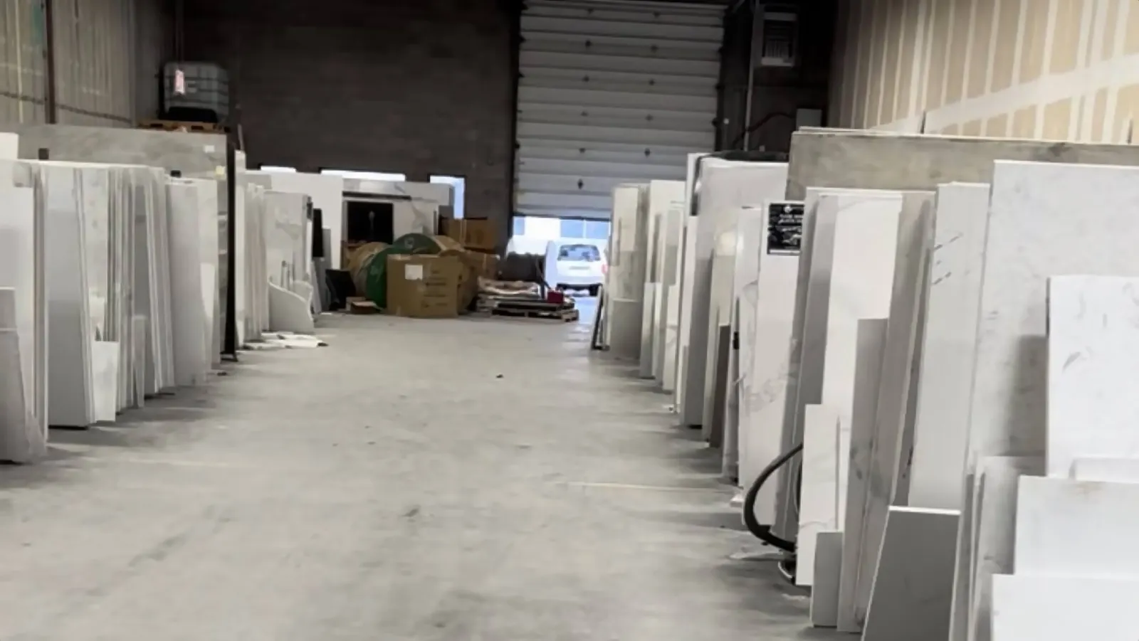 Racks of stone slabs at The Stone Studio warehouse